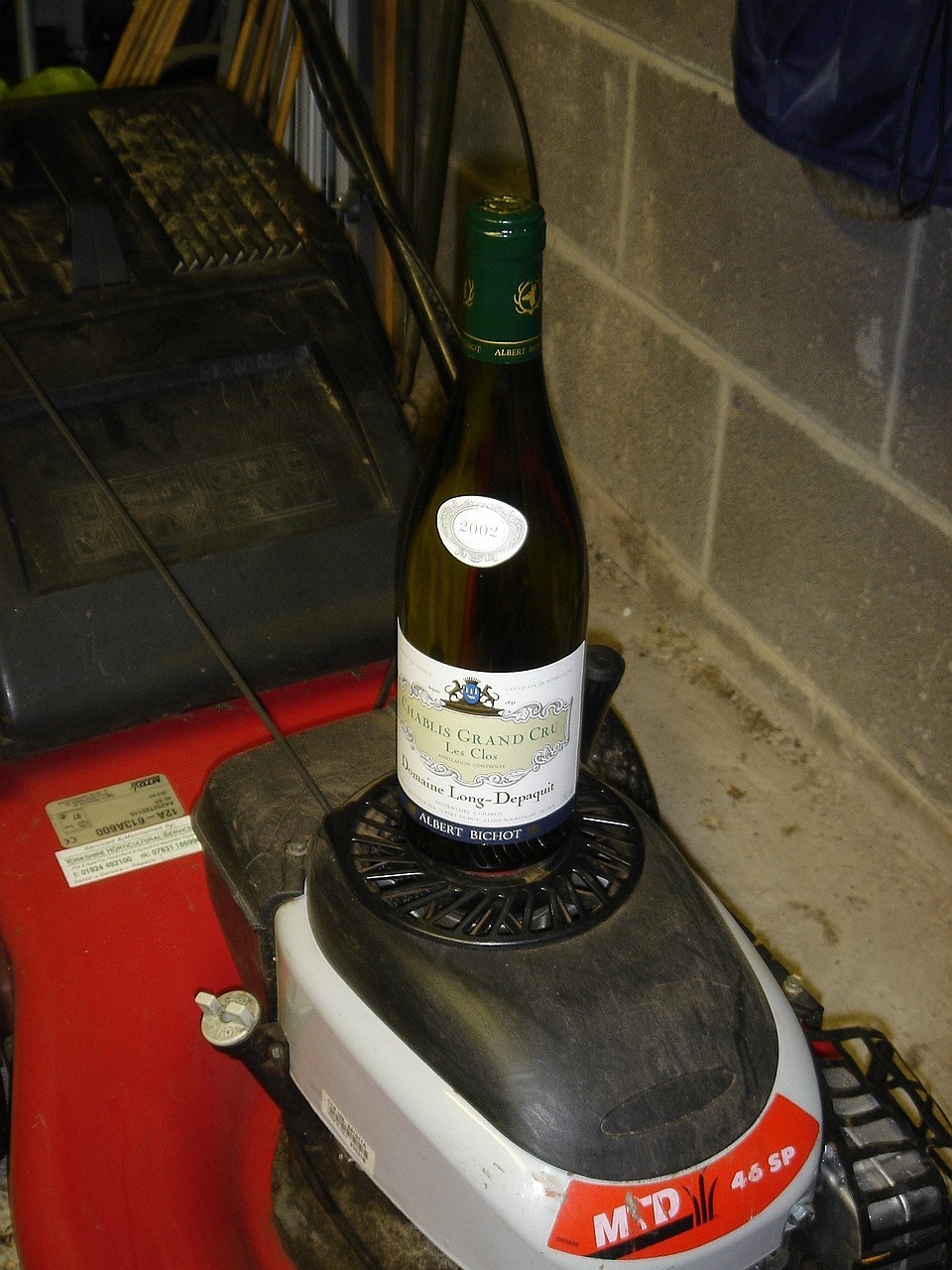 Donâ€™t try this at home - a Grand Cru Chablis balancing precariously on my lawn mower (for some reason)