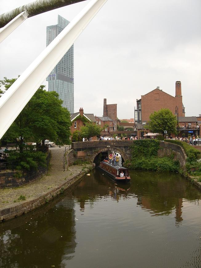 The very impressive Beetham Tower in the background  whilst a canal boat with a skiffle band goes through a lock in Castlefield (for some reason)