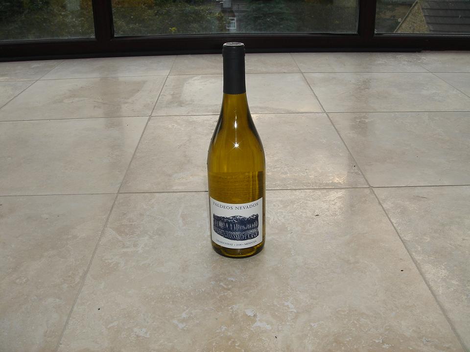 My beautiful travertine floor (about to get ripped out) and a bottle of Faldeos Chardonnay (for some reason)