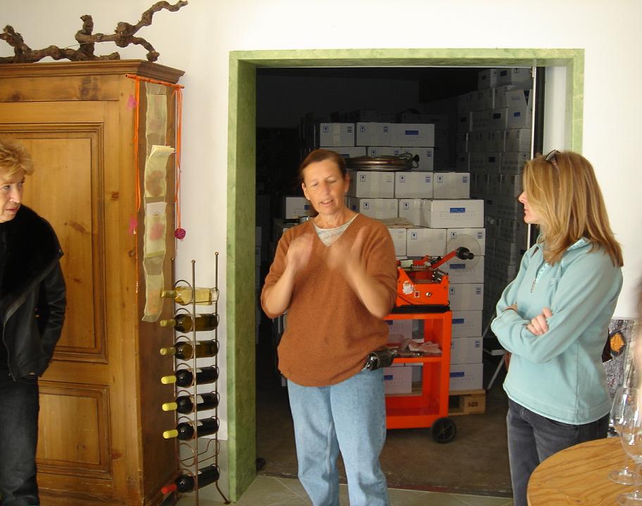 Marie-Bernard in full and enthusiastic flowâ€¦but this time I am charmed by the quantity of wine in the store behind her.